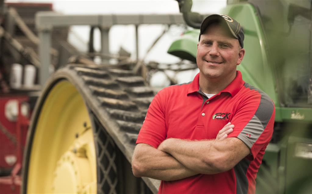 Image of Red Gold Growers Eck Family Farms from Boggstown Indiana Chris Eck in front of tractor