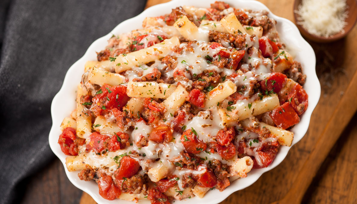 Baked Ziti with Diced Tomatoes in oval white oven dish
