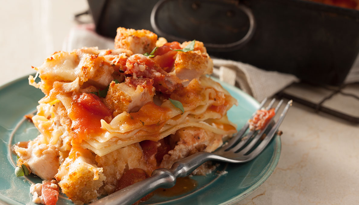 Image of Chicken Parmesan Lasagna on blue plate with fork