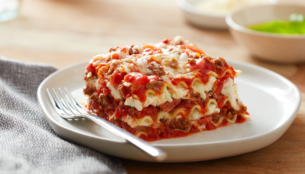 Classic Lasagna plated Image of Classic Lasagna on white plate with a fork