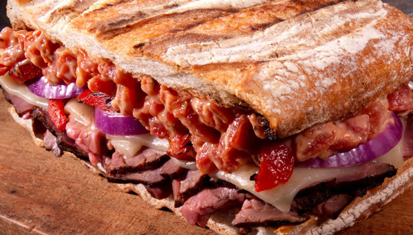 Image of roast beef panini with tomato aioli cheese and sliced red onion